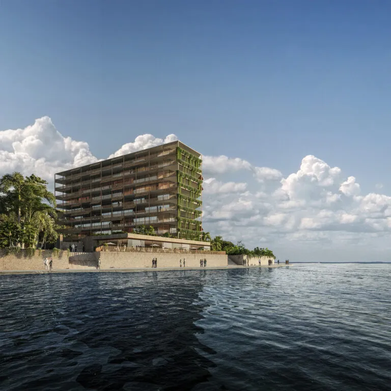 Waterfront apartment building with planted green balconies, seen across calm water